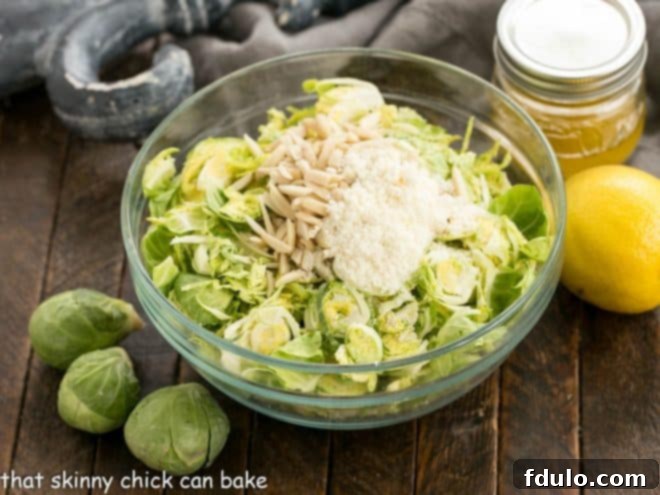 A top-down view of various ingredients laid out on a wooden surface, including fresh Brussels sprouts, lemons, olive oil, and various spices, ready for making the salad.