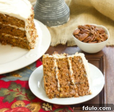 Close-up of a generously frosted Caramel Filled Carrot Cake, showing the delightful texture of the frosting and hint of cake layers.