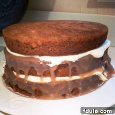 A square social media teaser image of a Caramel Filled Carrot Cake, emphasizing the luscious, gooey caramel filling between layers.