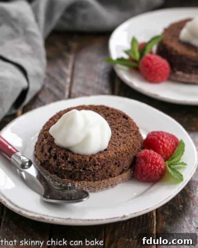 Chocolate Lava Cakes -Individual Chocolate Cakes with a molten hot, oozy chocolate filling! Lava cakes garnished with cream and berries
