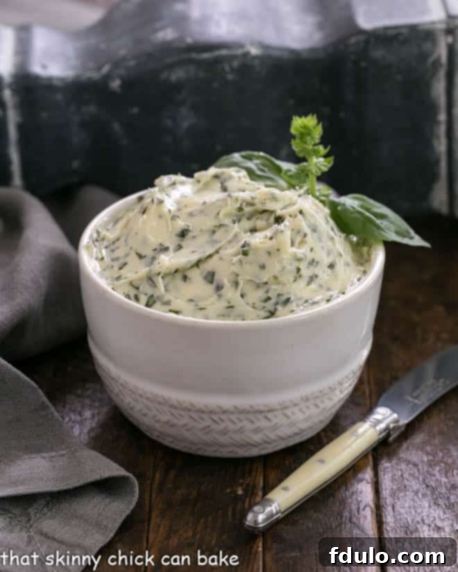 A bowl of fresh basil butter with a small knife for spreading, perfect for grilled corn.