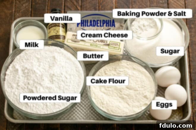 Organized display of gooey butter bar ingredients on a sheet pan, each clearly labeled.