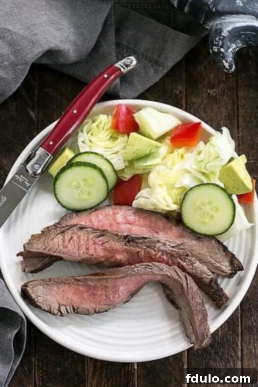 Grilled flank steak resting, then sliced on the diagonal for serving.