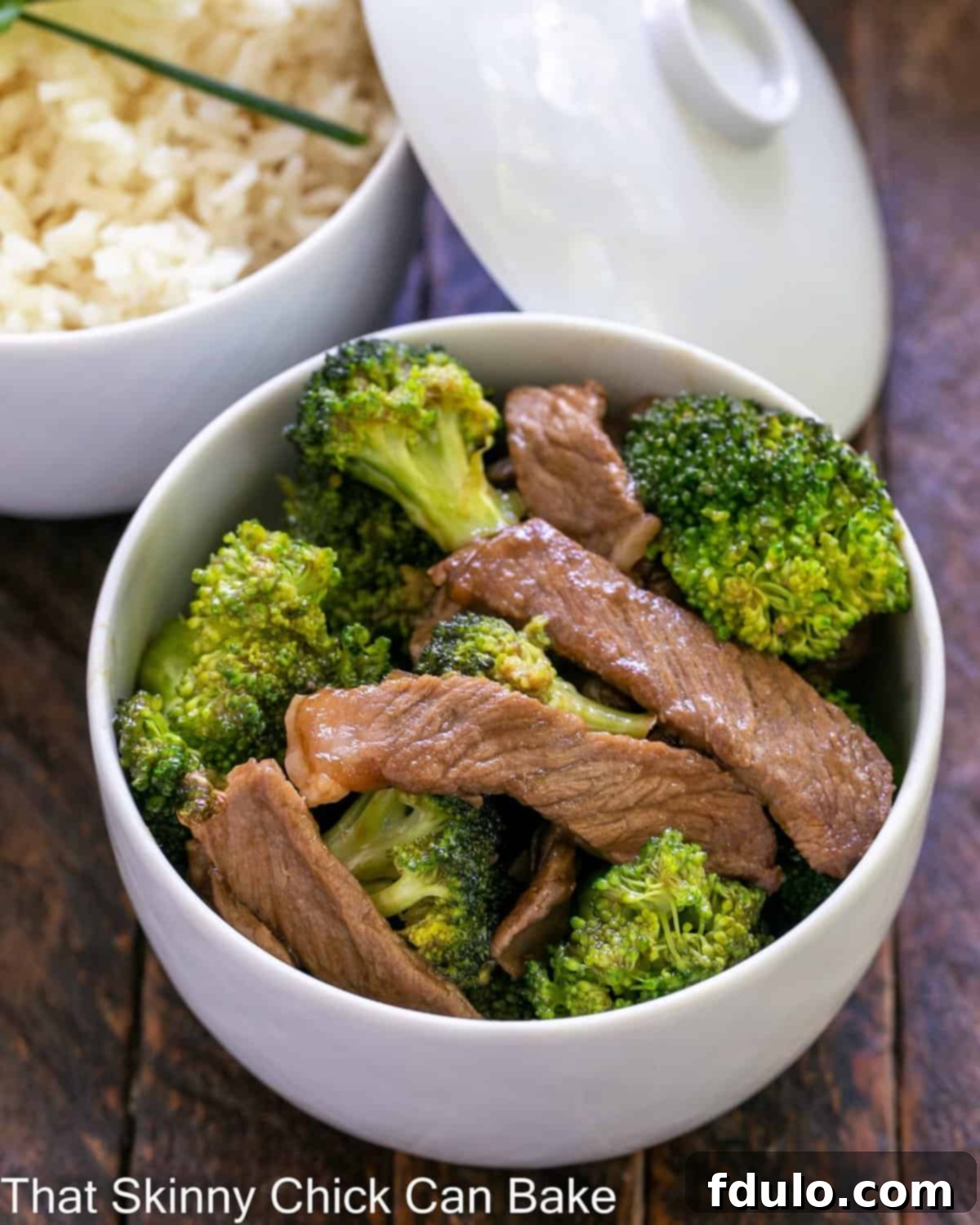 Overhead view of beef stir fry and rice in white ceramic bowlx