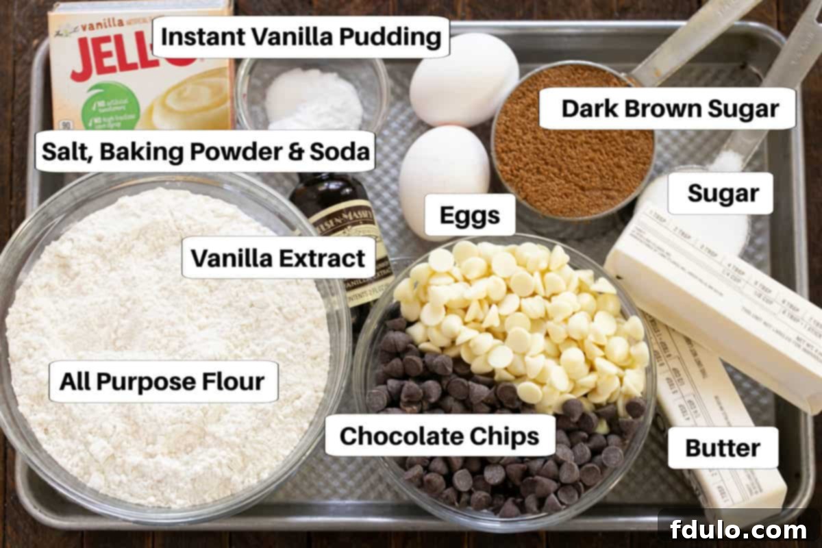 A selection of ingredients for chocolate chip pudding cookies laid out on a sheet pan, including flour, sugars, butter, eggs, pudding mix, and chocolate chips, each labeled for clarity.