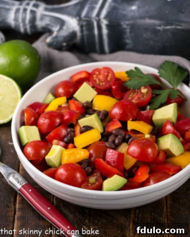 Chunky Guacamole Salad - all the fabulous flavors of guacamole in a refreshing avocado salad dressed with a lime vinaigrette.! Guacamole Salad or Avocado Salad in a white serving bowl with a red handle fork.