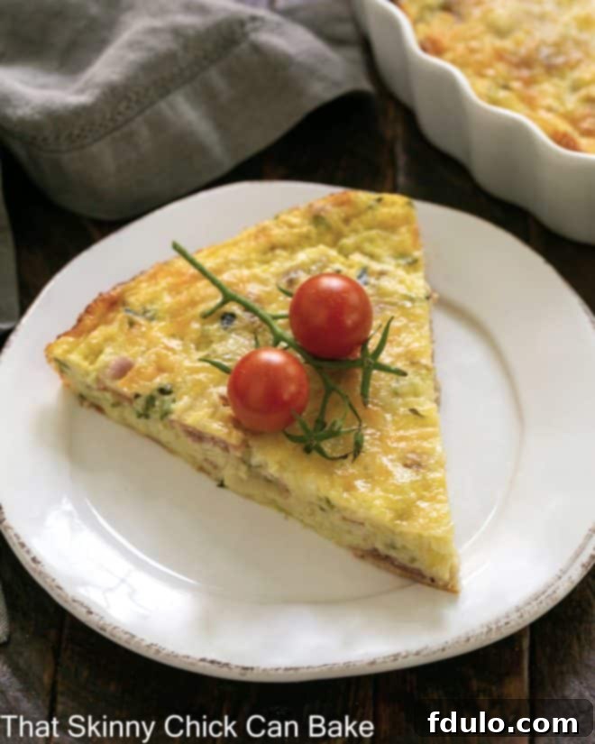 Savory Zucchini and Prosciutto Quiche 2 Slice of Zucchini Quiche with Prosciutto garnished with cherry tomatoes on a white plate