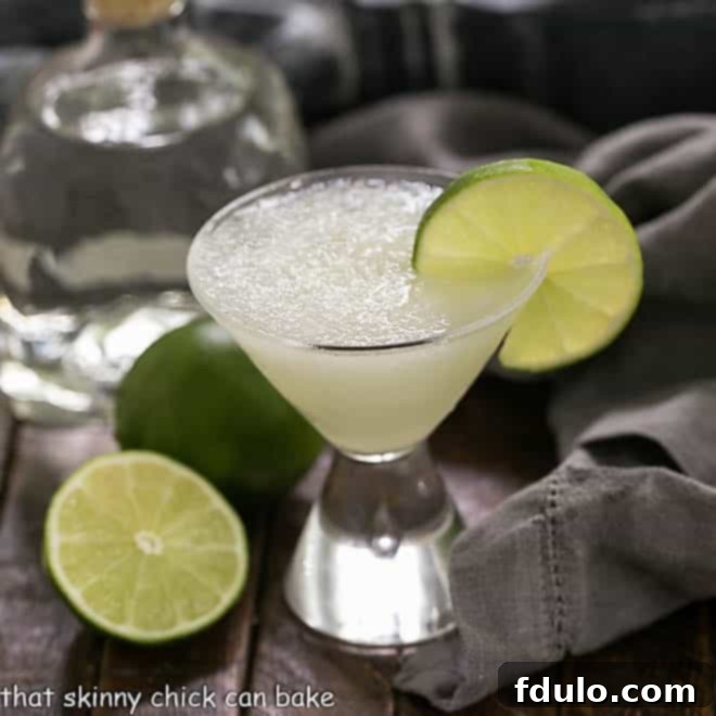 Easy 3-Ingredient Margarita in a small martini glass garnished with lime.