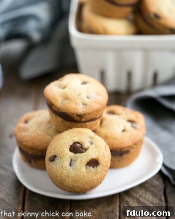 Close-up of Chocolate Chip Lava Cookies on a white plate with a bowl in the background, showing their soft texture and chocolate chips.