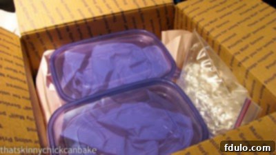 Assorted packages of chocolate treats carefully placed in a box, ready to be mailed to a college student.