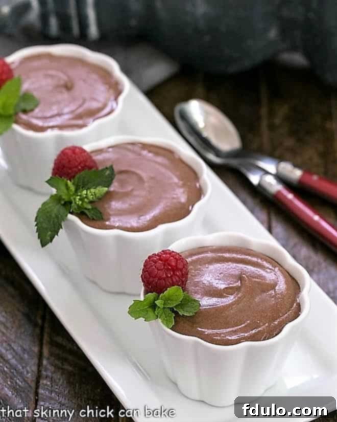 Mousseline au chocolate in white ramekins on a white tray.