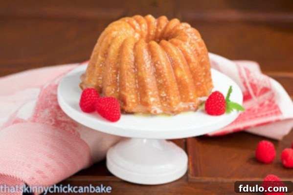 Close-up of a slice of White Chocolate Bundt Cake, showcasing its moist and tender crumb.