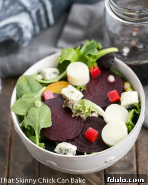 Delicious Roasted Beet Salad with Blue Cheese and Hearts of Palm - A Healthy Treat! A close-up view of the Beet Salad with Blue Cheese and Hearts of Palm, artfully presented in a white ceramic bowl, highlighting its vibrant ingredients.