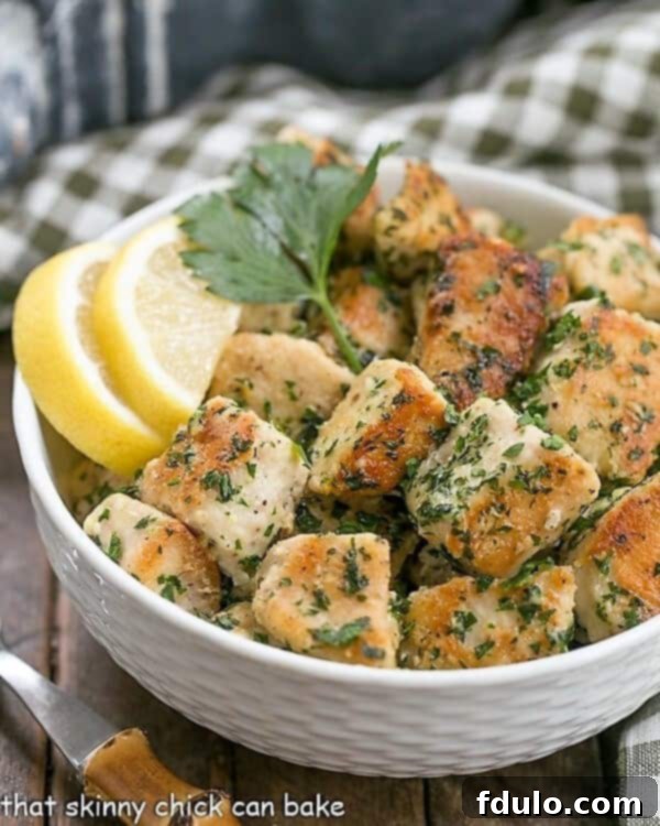 Delicious Chicken with Garlic and Parsley in a white basket weave bowl, garnished with fresh lemon slices and a sprig of vibrant parsley, ready to serve.