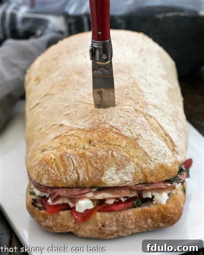 Compact Picnic Loaf 2 Picnic Sandwich before sliced on a ceramic tray