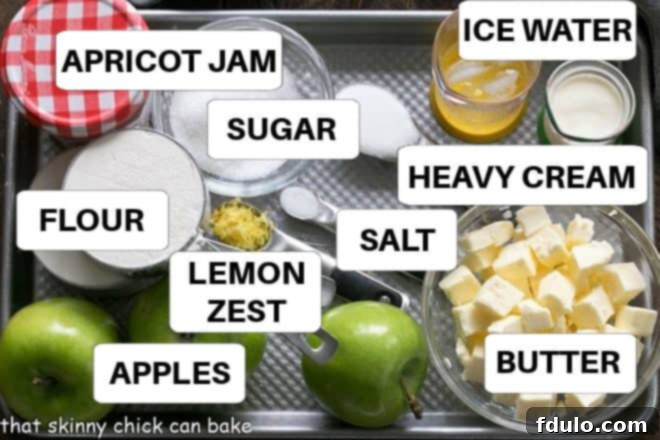 A collection of fresh ingredients for baking an apple crostata, including apples, butter, flour, sugar, and lemon, artfully arranged on a baking sheet with ingredient labels.