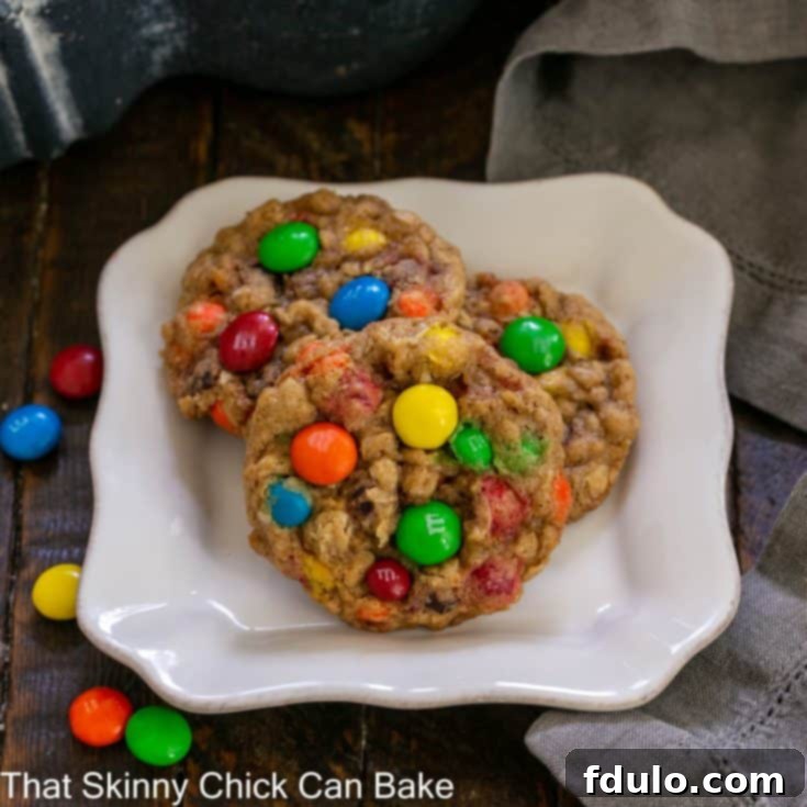 3 oatmeal M & M cookies on a square dessert plate