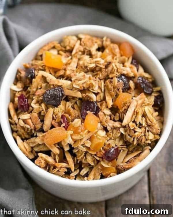 Golden Vanilla Granola with Sun-Kissed Fruits 2 Overhead view of vanilla granola with dried fruit in a white bowl, ready to serve.