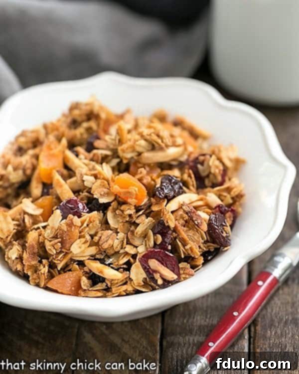 Golden Vanilla Granola with Sun-Kissed Fruits 3 Vanilla Granola with Dried Fruit and vanilla in a white scalloped cereal bowl