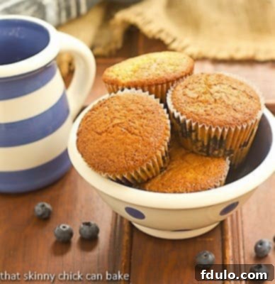 Sour Cream Blueberry Muffins in a white ceramic bowl with blue polka dots