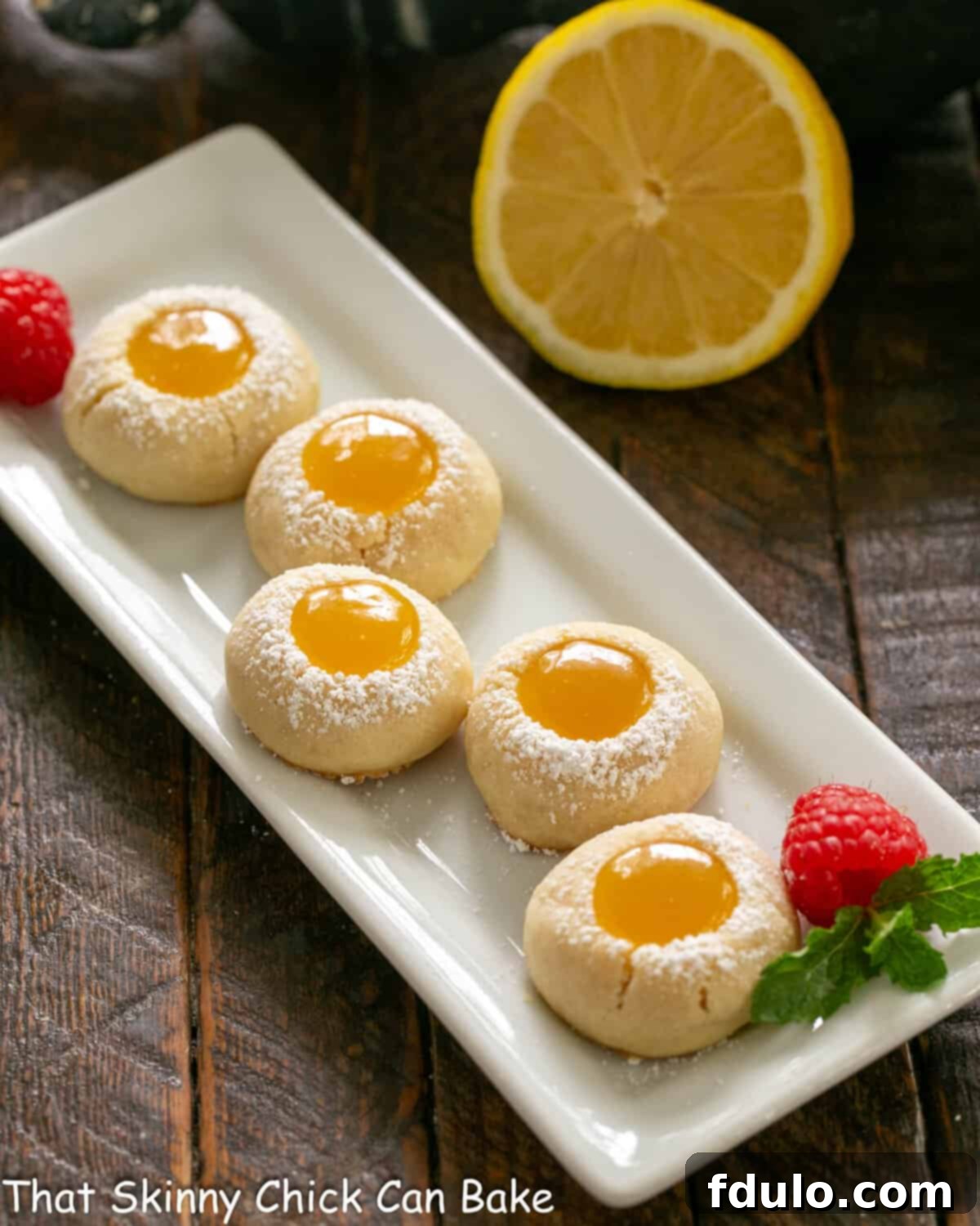 Lemon thumbprints on a white serving dish, beautifully arranged and ready to be enjoyed.