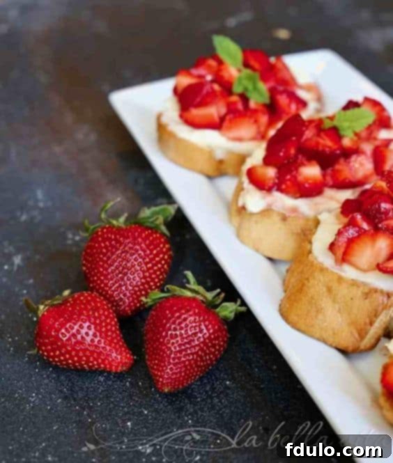 tray of strawberry crostini with 3 fresh berries