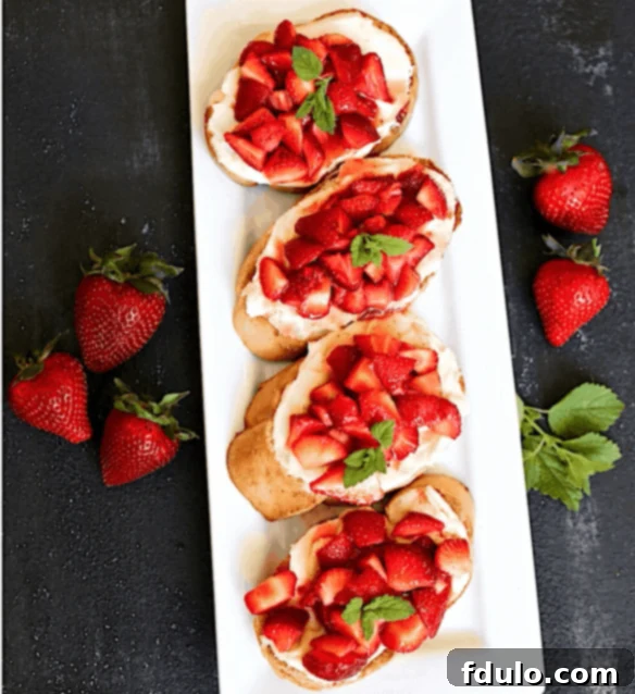 Overhead view of white tray with strawberry crostini