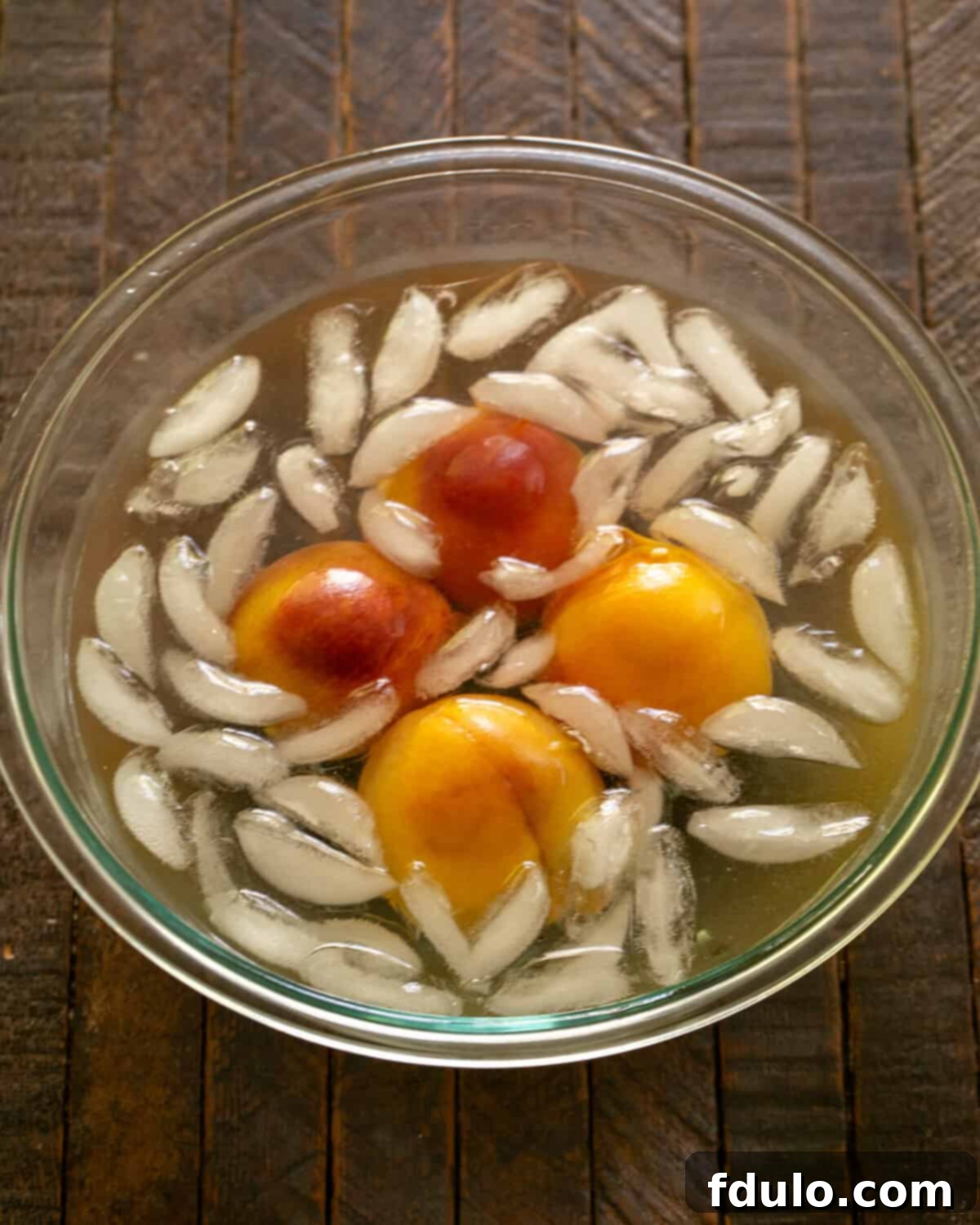 Step 4: Blanching peaches in boiling water, then transferring to an ice bath, peeling, and slicing.
