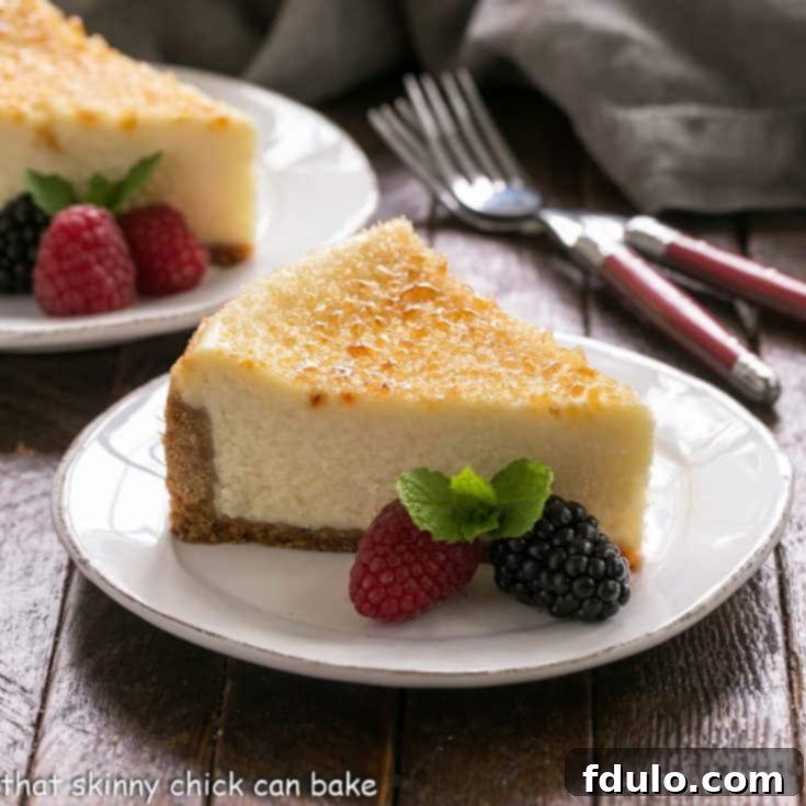 Creme Brulee cheesecake slice on a white dessert plate
