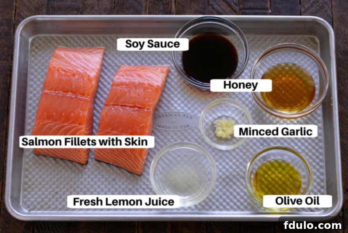 Marinated Salmon for Two Ingredients on a sheet pan with text labels, showcasing fresh lemon, honey, soy sauce, olive oil, garlic, and salmon fillets.