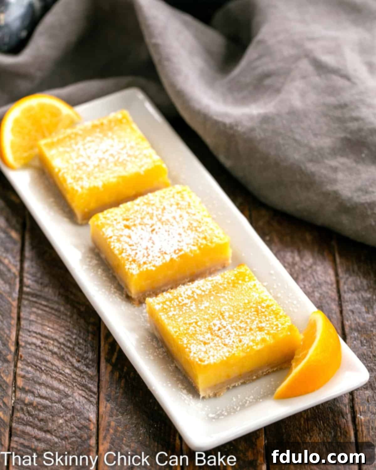 A white ceramic tray with 3 Meyer Lemon Bars.