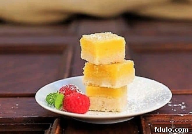 Meyer Lemon Bars stacked on a white plate