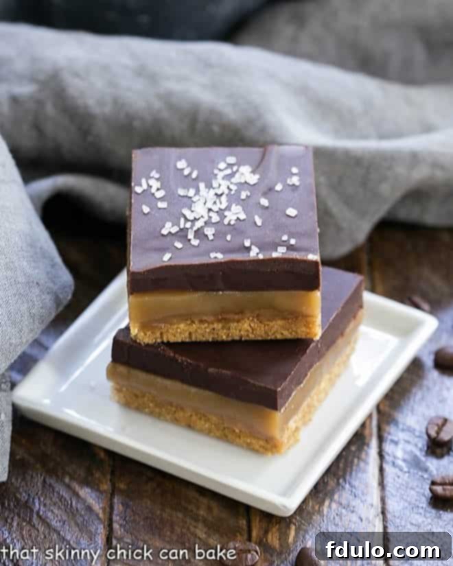 With a graham cracker crust, homemade caramel and an espresso or mocha ganache, these bars will make you swoon!! Caramel Espresso Bars stacked on a square white plate.