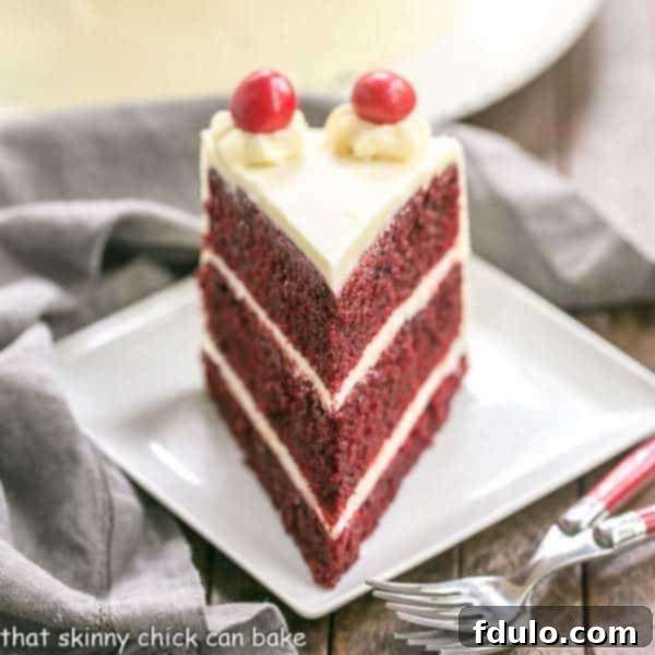 Red Velvet Cake with White Chocolate Cream Cheese Frosting | Triple layered decadence, slice removed