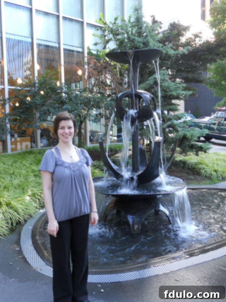 A joyful woman smiling brightly, enjoying the sights of Seattle, likely the birthday girl Katie.