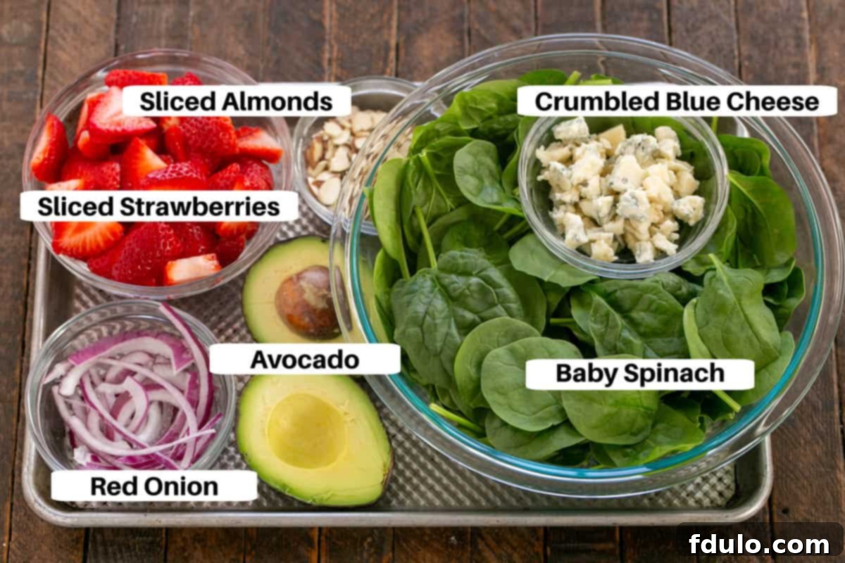 Spinach Salad with Strawberries and Blue Cheese ingredients with labels on a sheet pan.