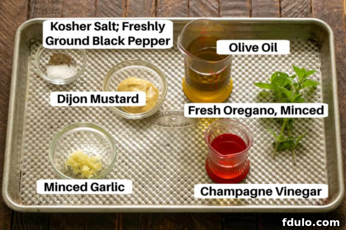 Restaurant-Quality Cobb Salad at Home 4 Ingredients for Cobb Salad dressing, clearly labeled, displayed on a metal sheet pan.