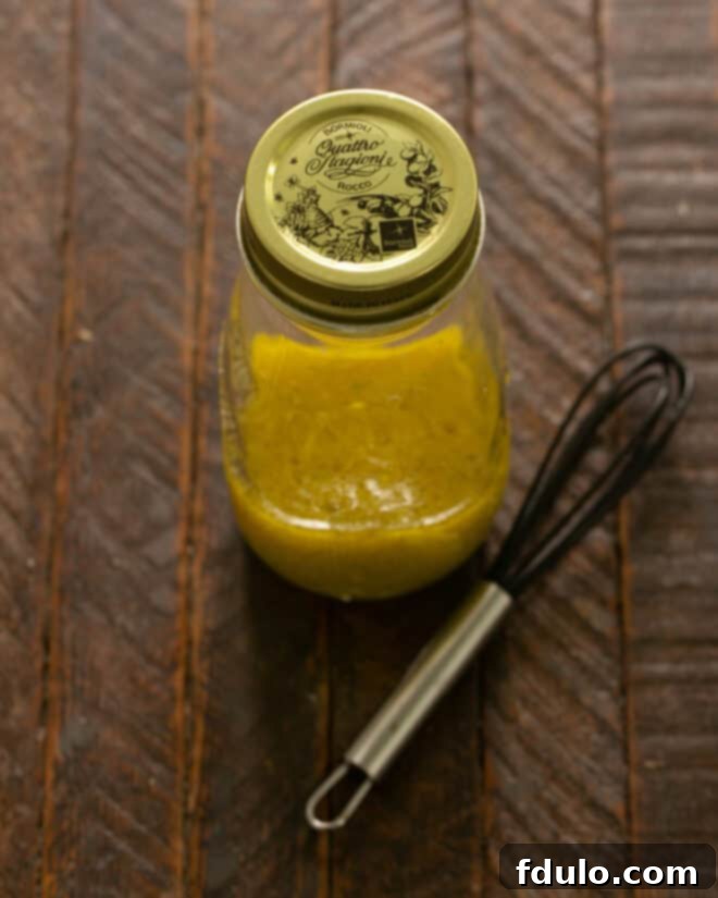 Restaurant-Quality Cobb Salad at Home 7 Cobb Salad dressing, perfectly emulsified, in a glass jar, ready to be drizzled.