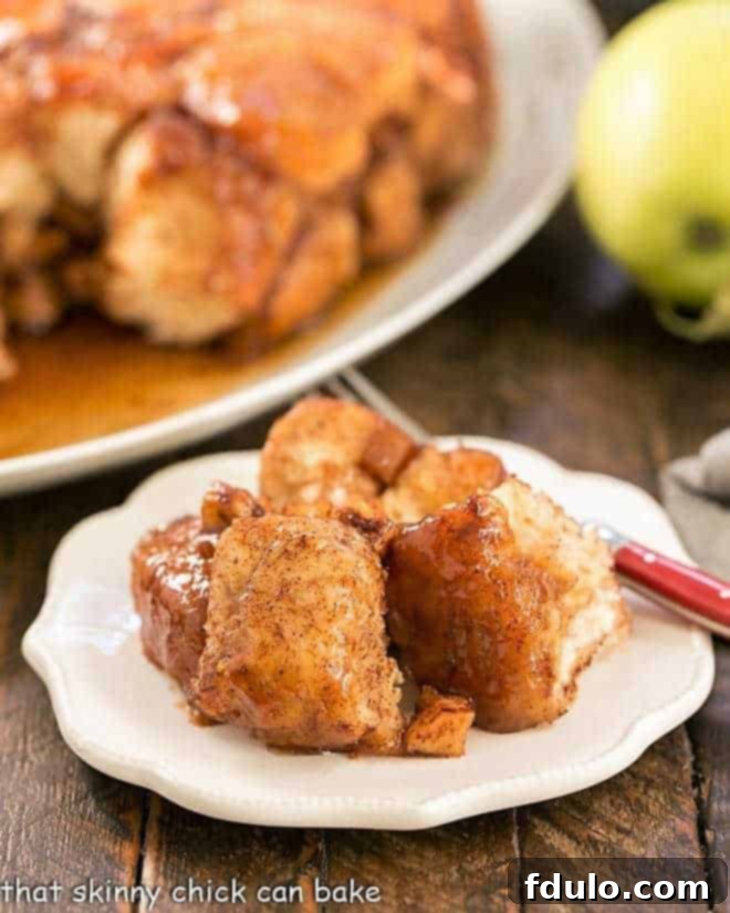 Gooey Apple Monkey Bread served on a small white plate, ready to be pulled apart and enjoyed.