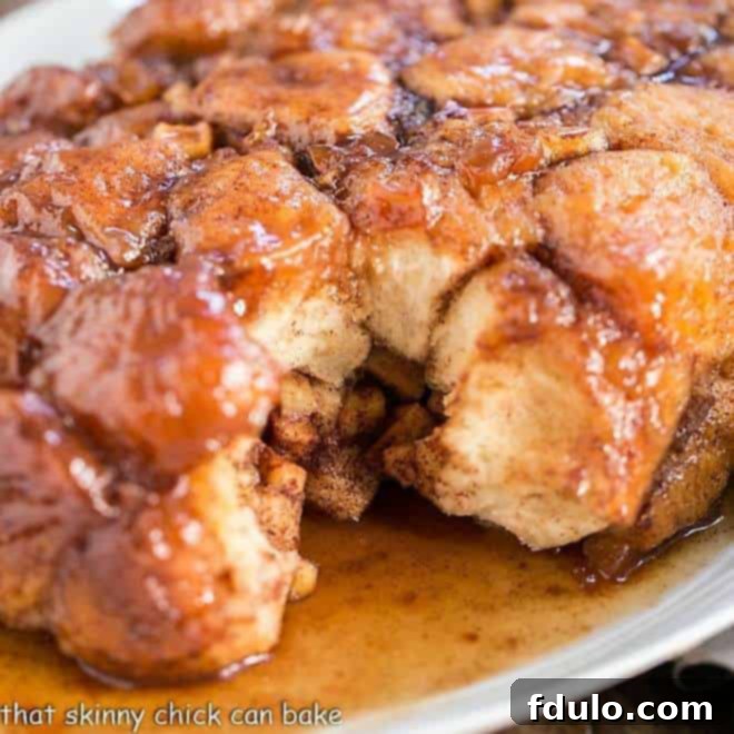 A large serving platter piled high with golden-brown Apple Monkey Bread, ready for guests to enjoy.