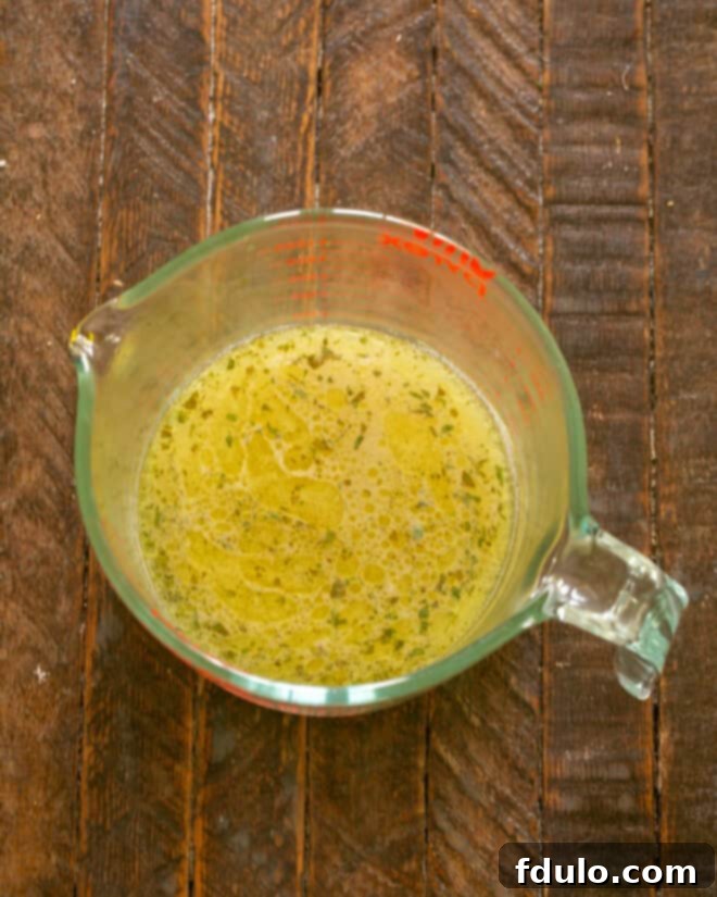 Prepared marinade in a liquid measuring cup ready for simmering.