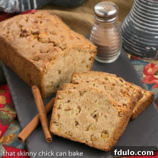 Apple Quick Bread - This moist apple bread recipe is perfect for snacking, breakfast or brunch! Apple Bread loaf and slices on a slate tray.