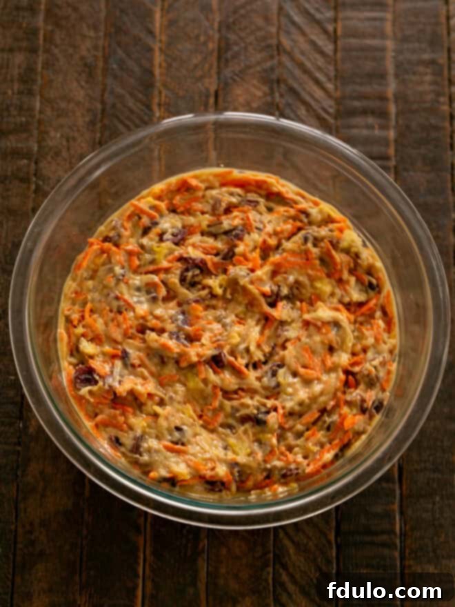 Fold in the carrots, pineapple, coconut, craisins and nut.