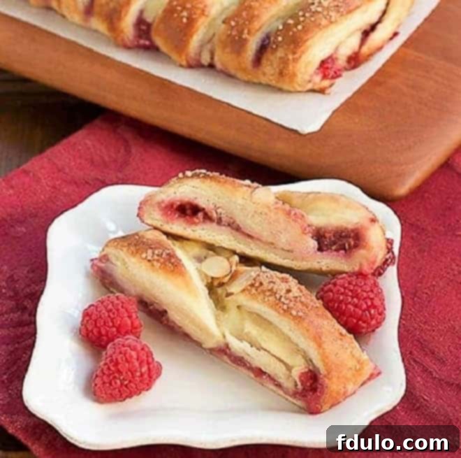 Raspberry Danish Braid slices on a white ceramic plate