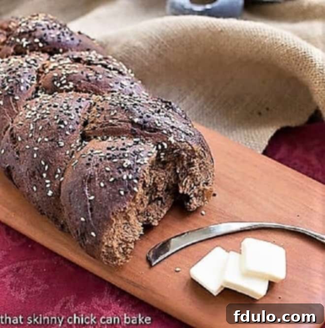 Pumpernickel Loaf on a wooden cutting board, showcasing its rich, dark crust