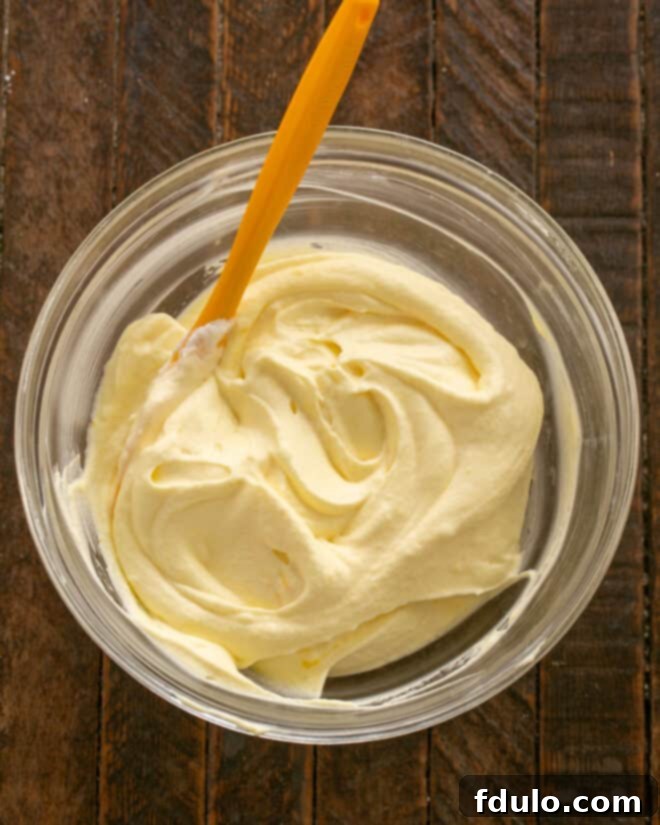 Mixing custard into whipped cream.