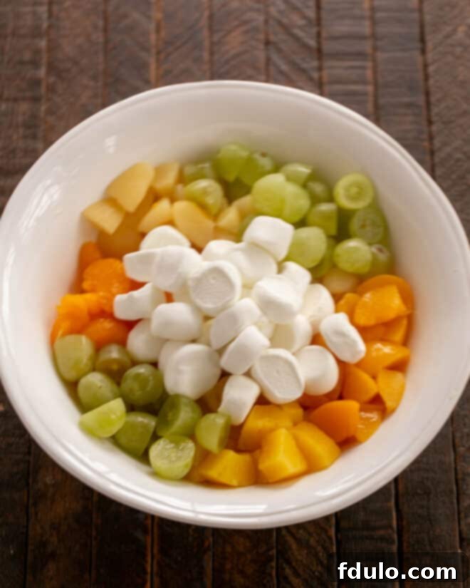Fruit and marshmallows in a serving bowl.