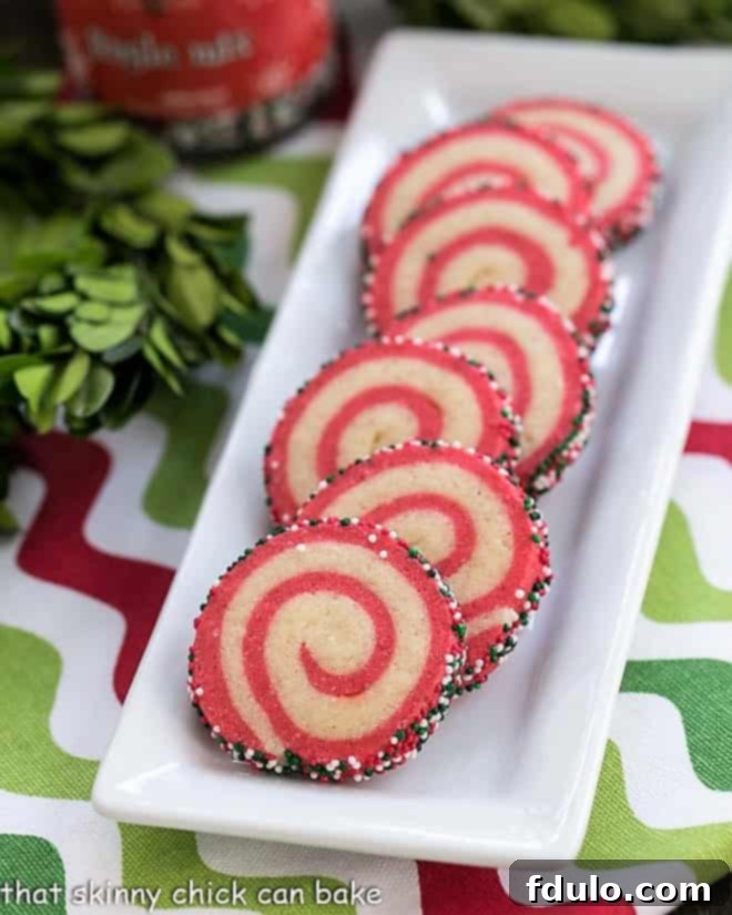 Holiday Pinwheel Cookies on a narrow white ceramic tray, elegantly arranged.