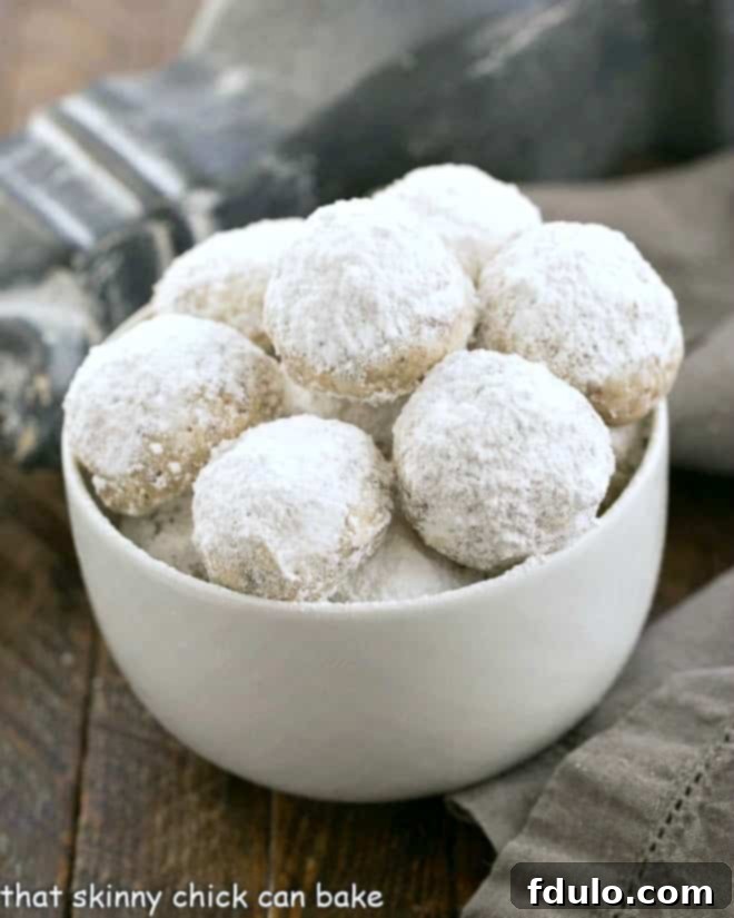 Noel Nut Balls with Toffee in a white dish, dusted with powdered sugar.