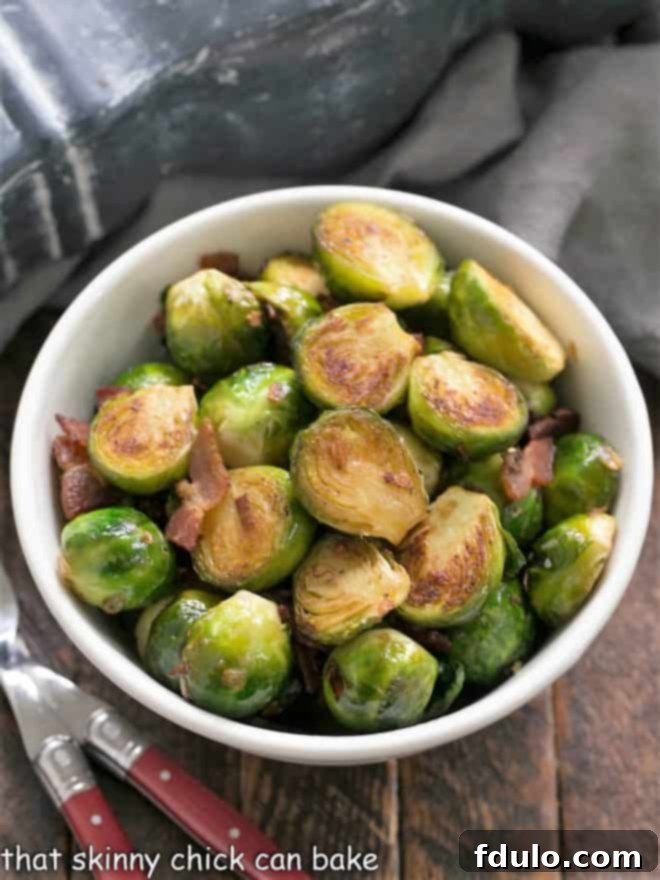 Overhead view of a bowl of sauteed brussels sprouts with bacon